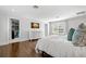 Bright bedroom with white trim, hardwood floors, walk in closet, and a large window at 3412 W Mckay Ave, Tampa, FL 33609