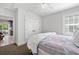 Well-lit bedroom with a ceiling fan, closet, and a door leading to the backyard at 3412 W Mckay Ave, Tampa, FL 33609