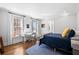 Bright bedroom featuring a large window, hardwood floors and a comfortable blue bed at 3412 W Mckay Ave, Tampa, FL 33609