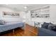 Spacious bedroom with hardwood floors, a built-in desk, and a comfortable seating area at 3412 W Mckay Ave, Tampa, FL 33609