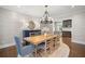 Formal dining room featuring a wood table, buffet, area rug, and modern chandelier at 3412 W Mckay Ave, Tampa, FL 33609