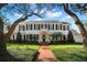Charming two-story white home with classic black shutters, manicured lawn, and beautiful tree coverage at 3412 W Mckay Ave, Tampa, FL 33609