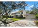 Classic two-story home with black shutters, manicured lawn, mature trees, and a three-car garage at 3412 W Mckay Ave, Tampa, FL 33609