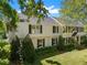 View of the home's exterior, with well-maintained lawn, mature landscaping, and classic architecture, inviting curb appeal at 3412 W Mckay Ave, Tampa, FL 33609