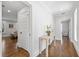 Bright hallway with hardwood floors, white trim, and stylish furnishings at 3412 W Mckay Ave, Tampa, FL 33609