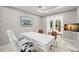 Bright home office with large white desk and access to the outdoor patio and pool area at 3412 W Mckay Ave, Tampa, FL 33609