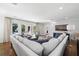 Spacious living area with plush sofa, hardwood floors, and views of the outdoor pool at 3412 W Mckay Ave, Tampa, FL 33609