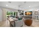Bright living room with stone tile, stylish seating and sliding glass doors to outdoor area at 3412 W Mckay Ave, Tampa, FL 33609