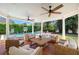 Outdoor living area with comfortable seating, ceiling fans, and views of the pool and backyard at 3412 W Mckay Ave, Tampa, FL 33609