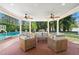 Inviting covered patio with brick flooring, ceiling fans, and comfortable seating near the pool at 3412 W Mckay Ave, Tampa, FL 33609