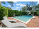 Beautiful pool area with lounge chairs, a basketball hoop, and a brick patio at 3412 W Mckay Ave, Tampa, FL 33609