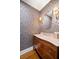 Stylish powder room with designer wallpaper, elegant vanity, and modern lighting at 3412 W Mckay Ave, Tampa, FL 33609