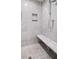 Modern shower with marble walls, bench, and built-in niche at 3412 W Mckay Ave, Tampa, FL 33609