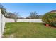 Large backyard with a well maintained lawn and a white vinyl privacy fence at 3613 Pendleton Way, Land O Lakes, FL 34639