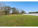 Expansive backyard with lush green grass and a secure white vinyl fence at 3613 Pendleton Way, Land O Lakes, FL 34639