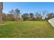 Large backyard with a large green lawn and a partial view of the home's exterior at 3613 Pendleton Way, Land O Lakes, FL 34639