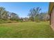 Expansive backyard featuring a large grassy area and mature trees, perfect for outdoor activities at 3613 Pendleton Way, Land O Lakes, FL 34639