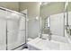 Bathroom featuring a shower with sliding glass doors and a marble countertop sink at 3613 Pendleton Way, Land O Lakes, FL 34639