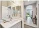 Well-lit bathroom featuring a marble countertop sink and views of the backyard at 3613 Pendleton Way, Land O Lakes, FL 34639