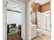 This bathroom has a white vanity and tub shower with glass doors at 3613 Pendleton Way, Land O Lakes, FL 34639