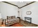 This cozy bedroom has wood floors, a bed, and a view of a mirror on the wall at 3613 Pendleton Way, Land O Lakes, FL 34639