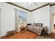 This bedroom features wood floors, a ceiling fan, and a window view at 3613 Pendleton Way, Land O Lakes, FL 34639