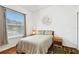 Cozy bedroom with a comfortable bed, wood floors and a window with natural light at 3613 Pendleton Way, Land O Lakes, FL 34639