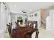 A dining room with tile floors, a ceiling fan, and a staircase at 3613 Pendleton Way, Land O Lakes, FL 34639