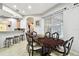 A dining room with tile floors featuring a dark wood table and stools near the kitchen area at 3613 Pendleton Way, Land O Lakes, FL 34639