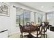 Dining room featuring a dark wood dining table, light gray walls, and bright windows at 3613 Pendleton Way, Land O Lakes, FL 34639