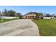 Spacious driveway leading to a well-maintained home with an expansive lawn at 3613 Pendleton Way, Land O Lakes, FL 34639