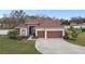 Charming home featuring a well-manicured lawn, a two-car garage, and lush landscaping at 3613 Pendleton Way, Land O Lakes, FL 34639