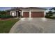 Charming single-story home featuring a long driveway, well-manicured lawn, and a two-car garage at 3613 Pendleton Way, Land O Lakes, FL 34639