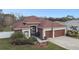 Charming single-story home featuring a manicured lawn, rock garden, and a convenient two-car garage at 3613 Pendleton Way, Land O Lakes, FL 34639