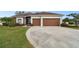 Well-maintained home featuring a two-car garage and manicured landscaping at 3613 Pendleton Way, Land O Lakes, FL 34639