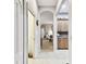 A hallway with tile flooring leads into the living room and kitchen area at 3613 Pendleton Way, Land O Lakes, FL 34639