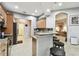 Kitchen with granite counters, breakfast bar, and open access to other living areas at 3613 Pendleton Way, Land O Lakes, FL 34639