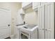 Efficient laundry room featuring white cabinets and modern LG washer and dryer units at 3613 Pendleton Way, Land O Lakes, FL 34639