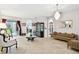 Elegant living room with tile floors, chandelier, and furniture at 3613 Pendleton Way, Land O Lakes, FL 34639
