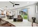 Open concept living room with tile floors, ceiling fan and sliding glass door to backyard at 3613 Pendleton Way, Land O Lakes, FL 34639