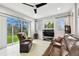 A living room with tile floors and sliding glass doors to the backyard and patio at 3613 Pendleton Way, Land O Lakes, FL 34639