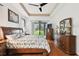 Bright main bedroom featuring hardwood floors, a tray ceiling and a sliding glass door to backyard at 3613 Pendleton Way, Land O Lakes, FL 34639