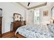Spacious main bedroom featuring a tray ceiling, hardwood floors, and ensuite bathroom access at 3613 Pendleton Way, Land O Lakes, FL 34639