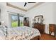 A main bedroom with hardwood floors and a sliding glass door to the backyard at 3613 Pendleton Way, Land O Lakes, FL 34639