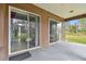 A covered patio with sliding doors leading into the home offering views of the yard at 3613 Pendleton Way, Land O Lakes, FL 34639