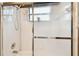Step into this shower with white tile, handheld shower head, and sliding glass doors at 3613 Pendleton Way, Land O Lakes, FL 34639