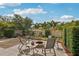 Beautifully landscaped backyard includes a fire pit with seating, surrounded by lush greenery and palm trees at 3655 Candia Ave, North Port, FL 34286