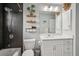 Stylish bathroom features a shower, modern vanity with framed mirror, and decorative shelving at 3655 Candia Ave, North Port, FL 34286