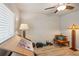 Bright bedroom featuring wood-look floors, a modern ceiling fan, and various decor at 3655 Candia Ave, North Port, FL 34286