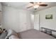 Comfortable bedroom with neutral tones, ceiling fan, and a peek into the en suite at 3655 Candia Ave, North Port, FL 34286